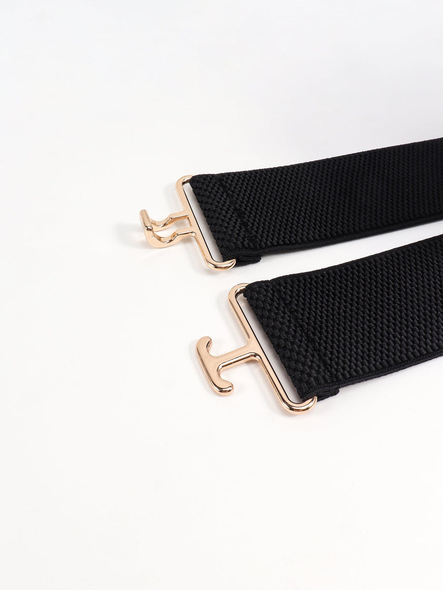 Black elastic belt with sculpted gold buckle detail