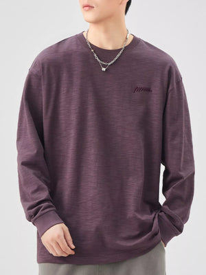 Oversized long-sleeve cotton tee in Sauce Purple with embroidered logo detail.