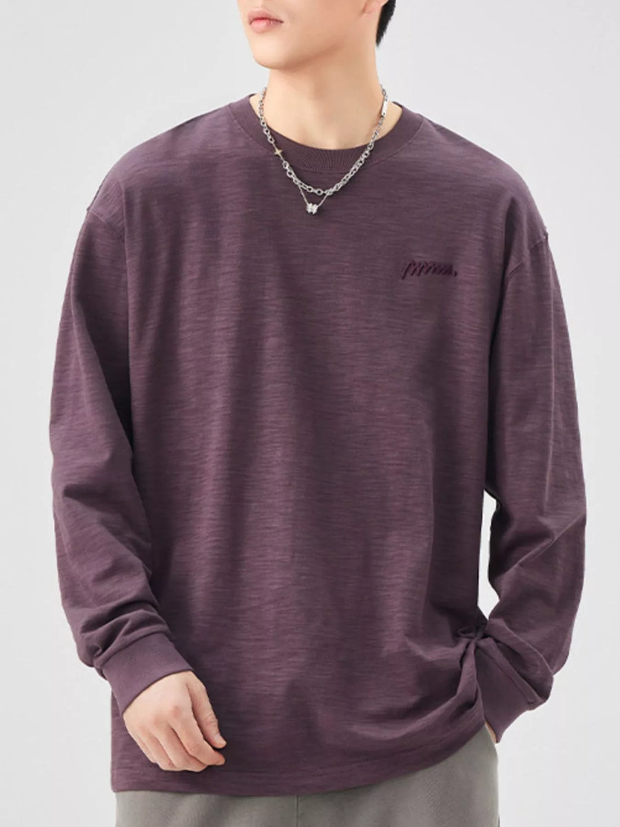 Oversized long-sleeve cotton tee in Sauce Purple with embroidered logo detail.