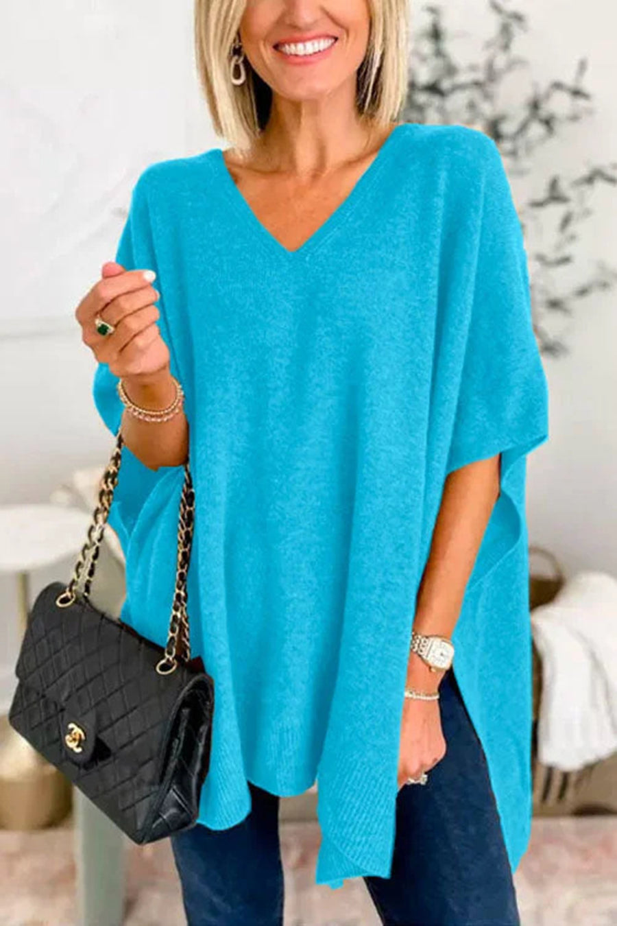 Cerulean relaxed V-neck knit poncho top with short sleeves and side slits.