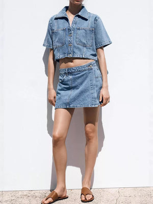 Denim cropped button-up top and skort set with contrast stitching.