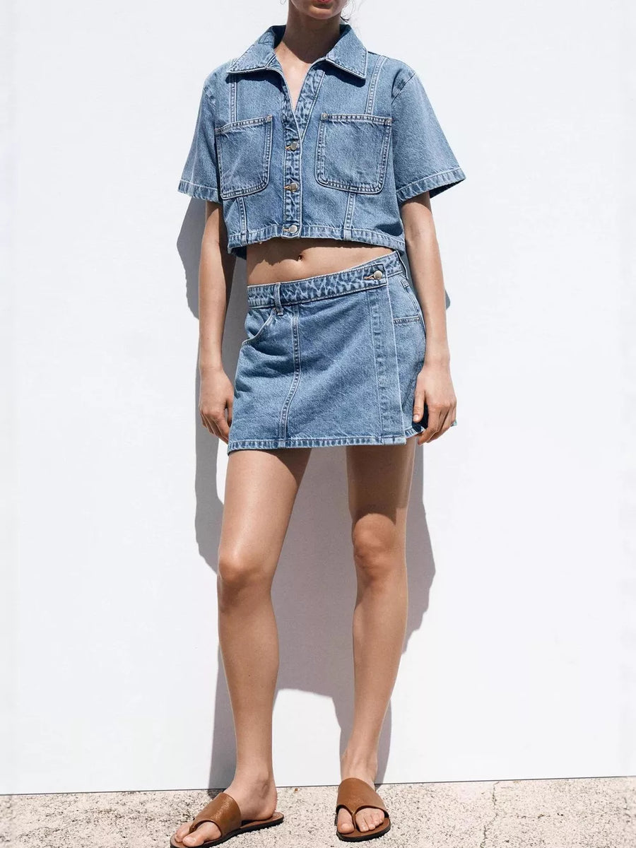 Denim cropped button-up top and skort set with contrast stitching.
