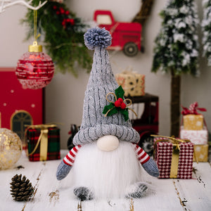 Illuminated knit gnome with gray hat and red striped arms.