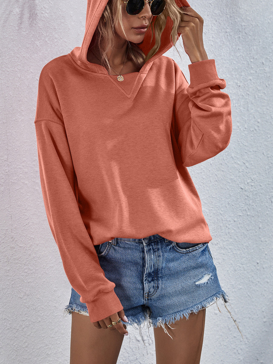 Boxy hooded sweatshirt in Tangerine with split neckline and cuffed sleeves.