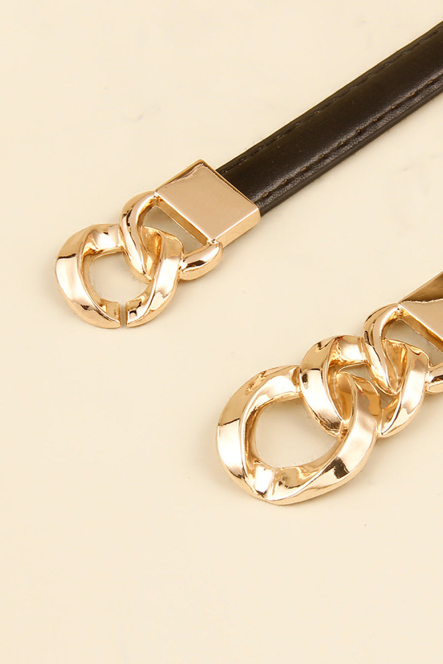 Black leather belt with gold chain link buckle detail
