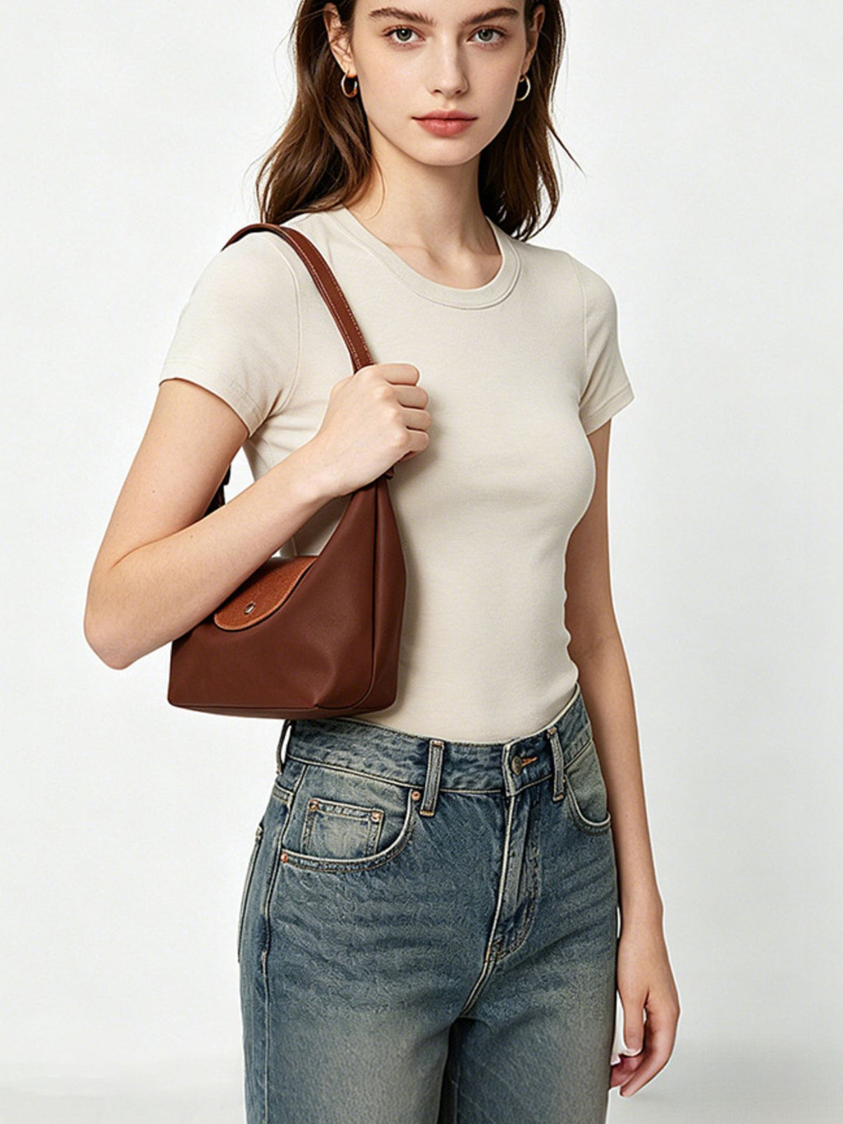 shoulder bag in brown featuring leather trim and curved fit
