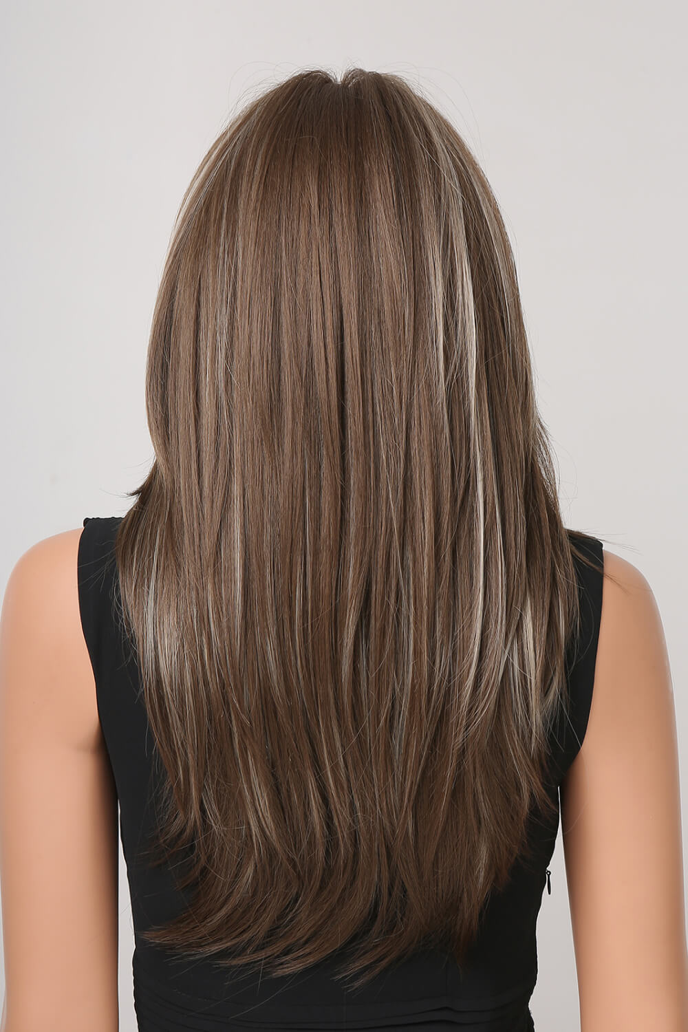 Layered synthetic wig in brown with blonde highlights and bangs, shown from the back.