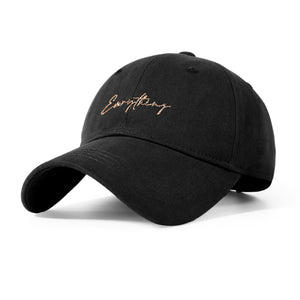 Black cotton baseball cap with gold cursive embroidery