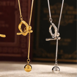 Gold and silver lariat necklaces with a gymnast charm and ball drop