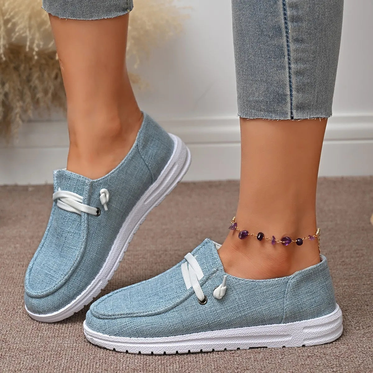 Dusty Blue linen-blend boat shoes with white laces and contrast sole.