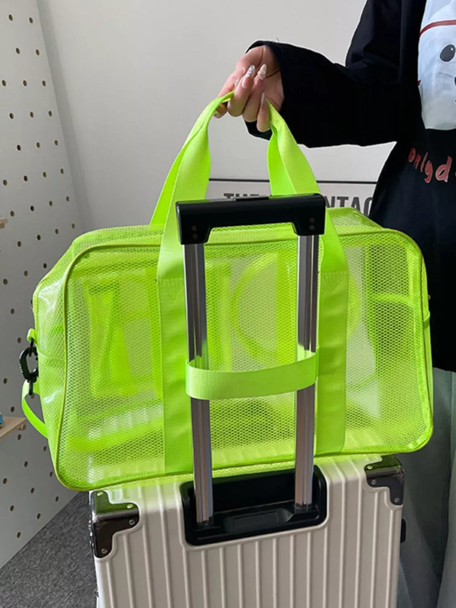 Fluorescent green mesh travel organizer bag with multiple pockets and top handles.