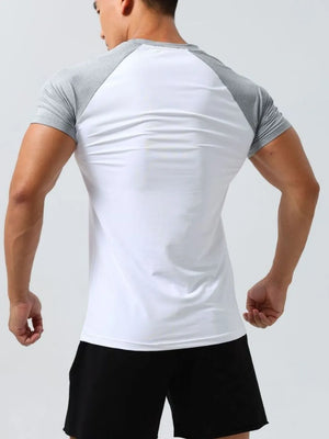 Raglan sleeve performance tee in white with gray sleeves and neckline.
