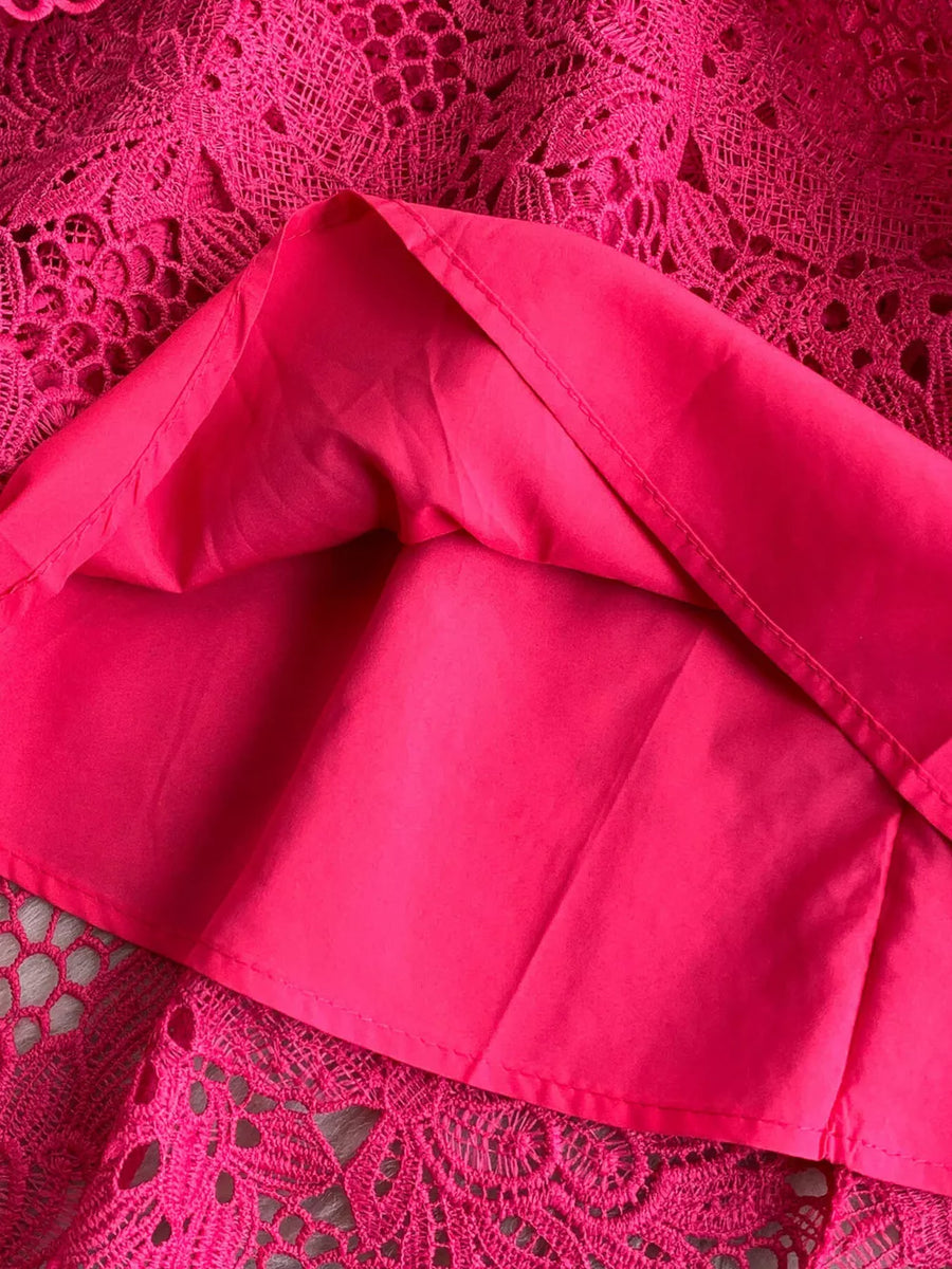 Fuchsia pink lace A-line dress with cutout detail and lining.