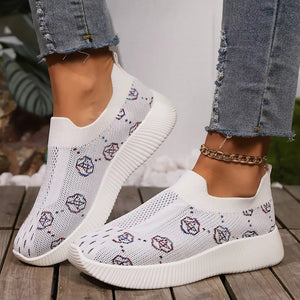 White breathable mesh slip-on sneakers with all-over pattern and gold ankle chain.