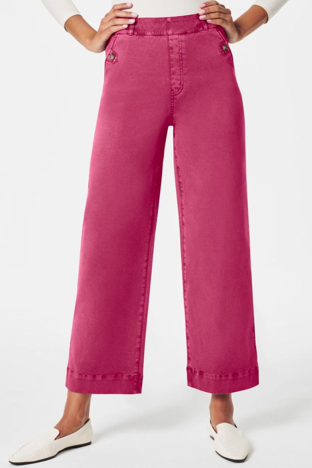 Fuchsia pink wide-leg utility denim trousers with button details and a cropped hem.