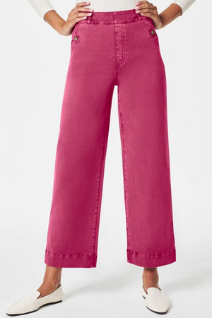 Fuchsia pink wide-leg utility denim trousers with button details and a cropped hem.