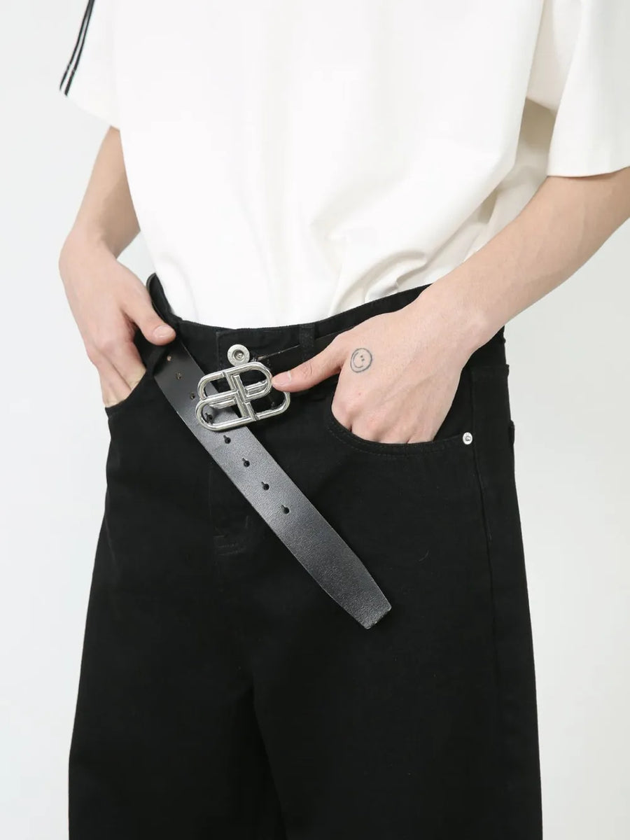 Black denim palazzo trousers with a silver buckle belt and button closure.