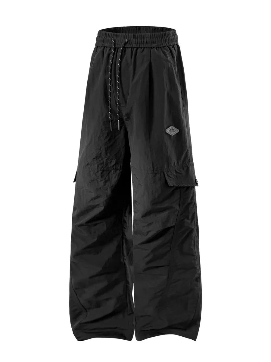 Black relaxed fit cargo sweatpants with drawstring and patch detail.