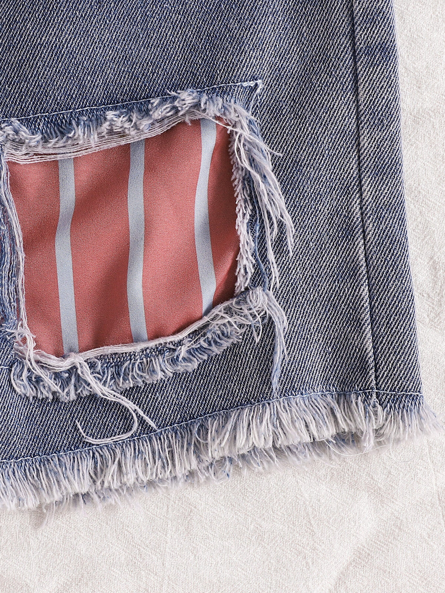 Distressed denim shorts with pink and blue striped lining and frayed hem.