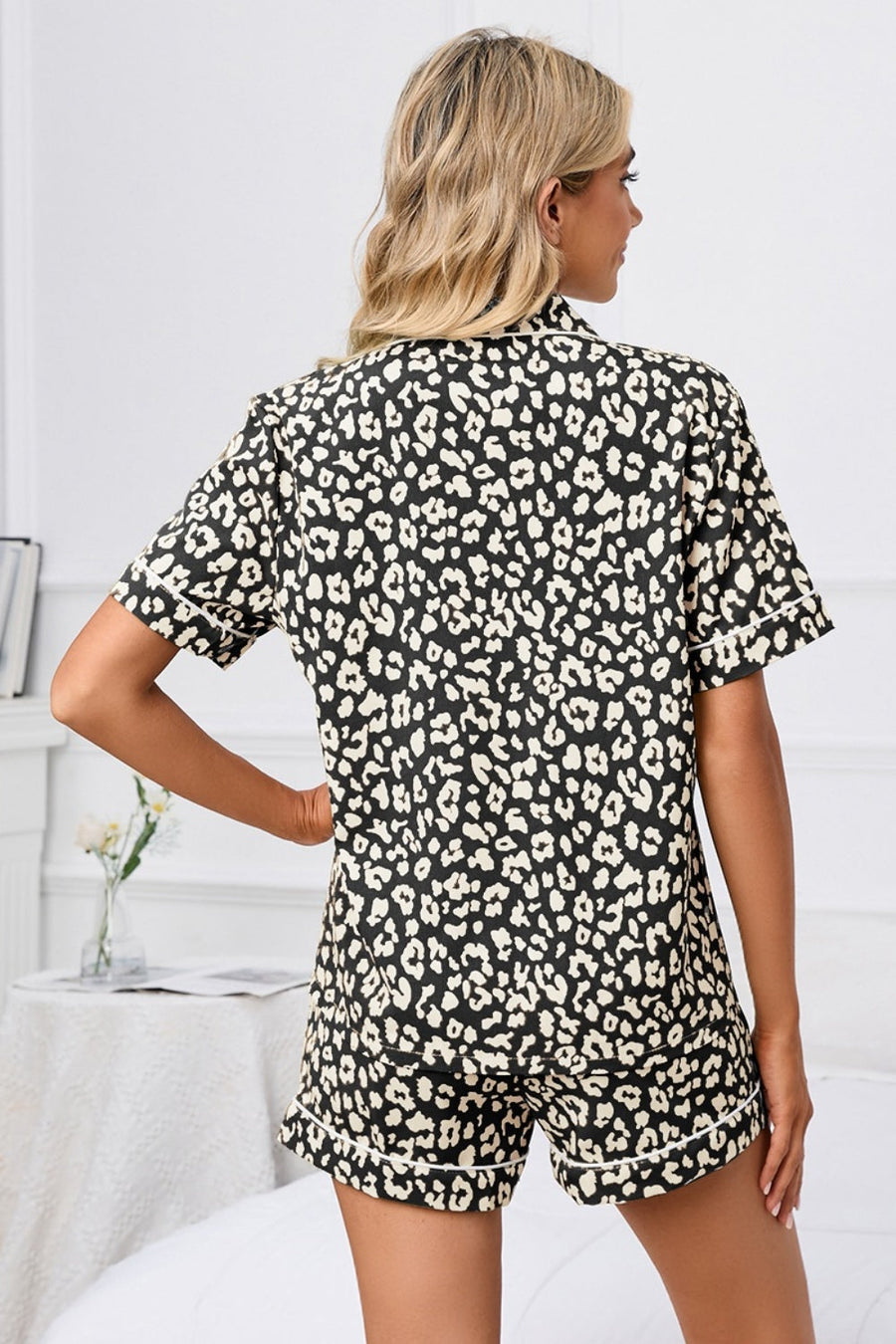 Pajama set with black and cream leopard print, short sleeves, and contrast piping.