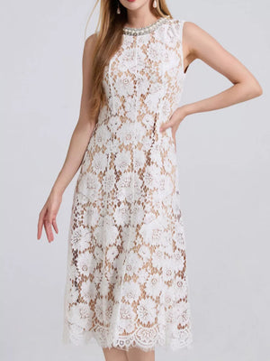 White lace dress with pearl embellished neckline and scalloped hem.