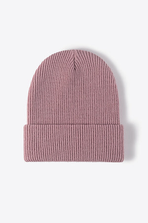 Pink ribbed knit beanie with a cuffed brim.
