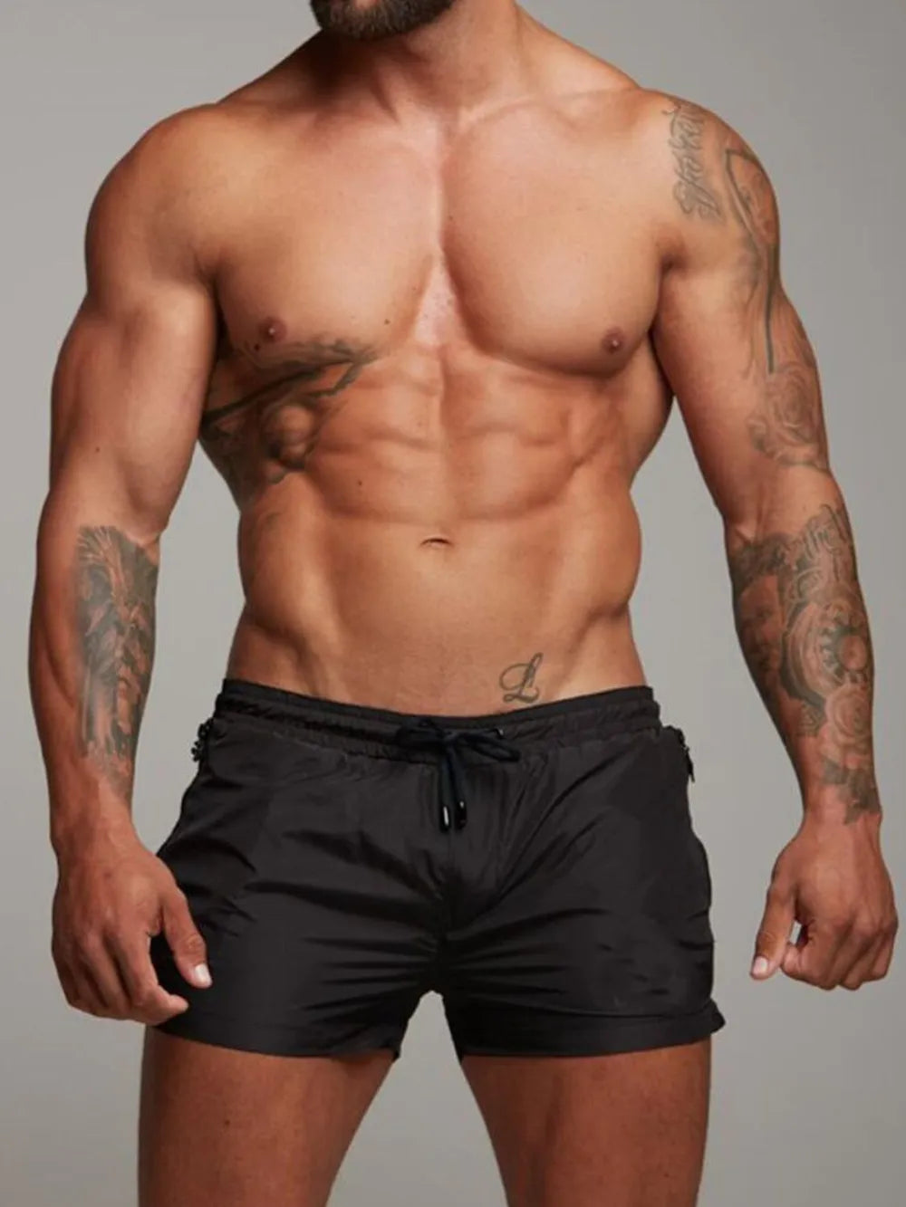 Black boardshorts with drawstring waist and zip pockets