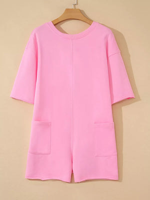 Pink cotton romper with half sleeves, crew neck, and two front pockets.