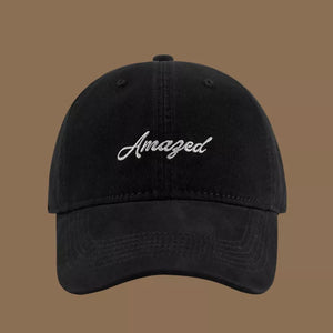 Black cotton baseball cap with white embroidered "Amazed" text