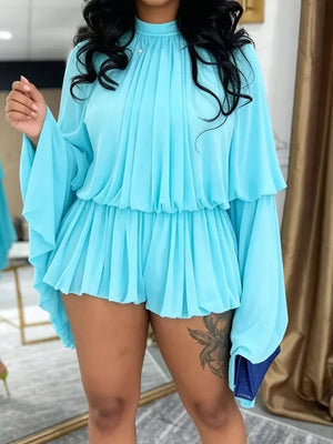 Light blue chiffon romper with high neck, tiered bell sleeves, and ruffled shorts.