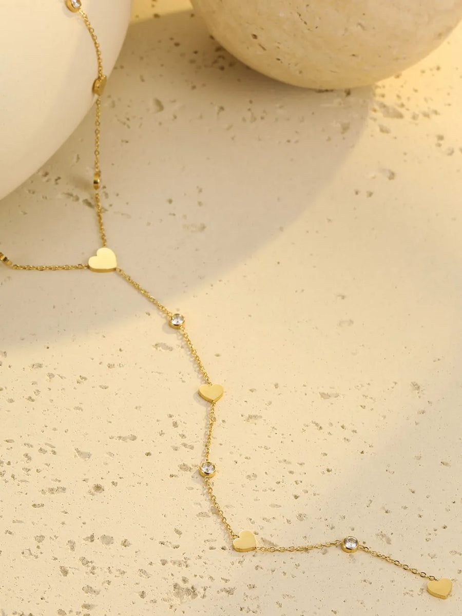 clear necklace featuring heart charms and geometric