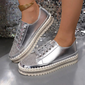 Silver rhinestone toe sneakers with chunky sole and lace-up closure.