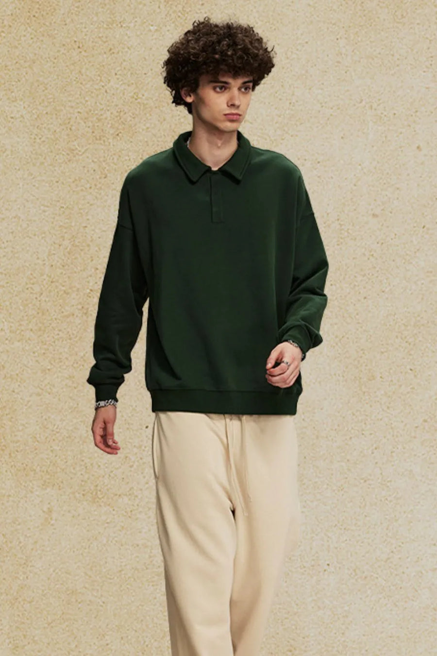 Dark green oversized polo sweatshirt with collar and long sleeves.