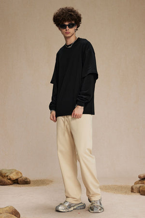 Black layered long sleeve shirt with cream drawstring pants