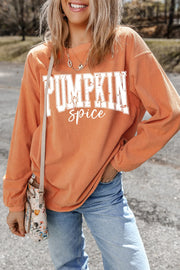 Textured corduroy sweatshirt in sherbet with white "Pumpkin Spice" graphic.