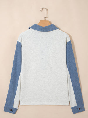 Heathered casual top with blue sleeves and button detail