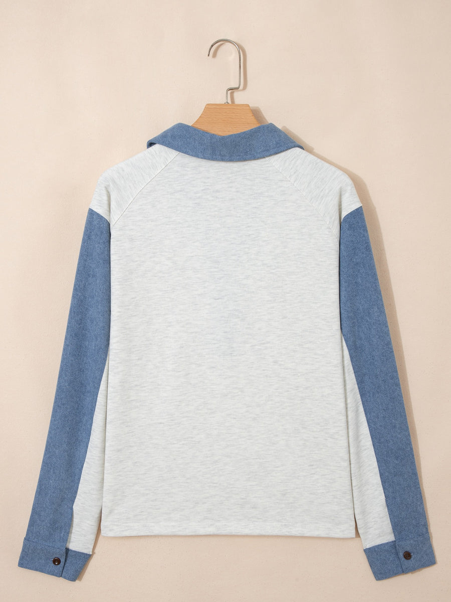 Heathered casual top with blue sleeves and button detail