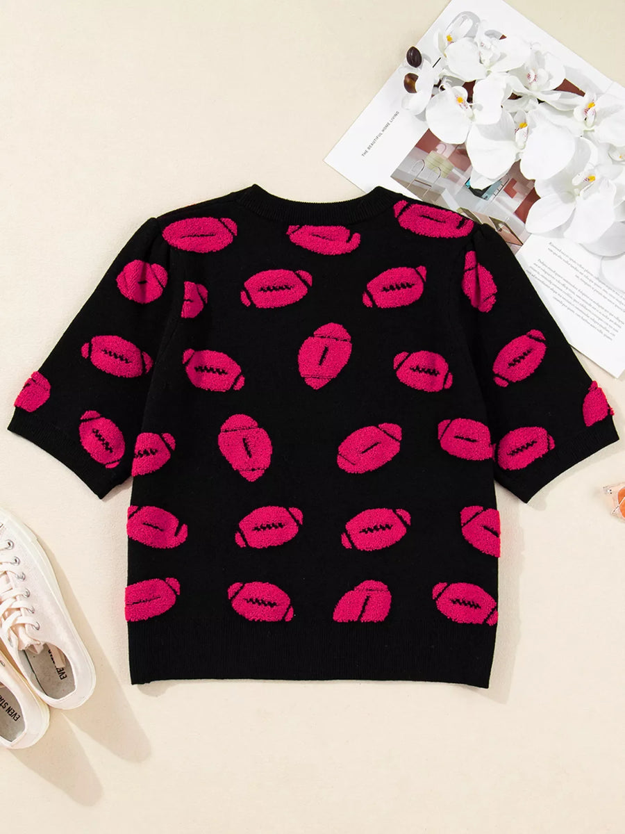 Black short-sleeve knit sweater with a playful pink football pattern.