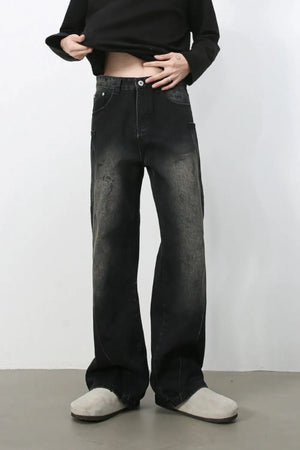 Faded wash wide leg denim jeans in dark, with a relaxed fit and distressed details.