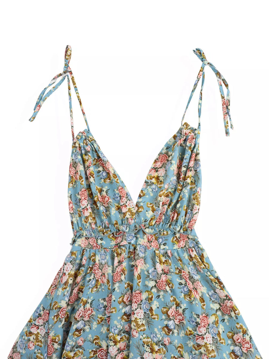 Vibrant floral print mini dress with tie-strap halter neckline and deep V-neck.