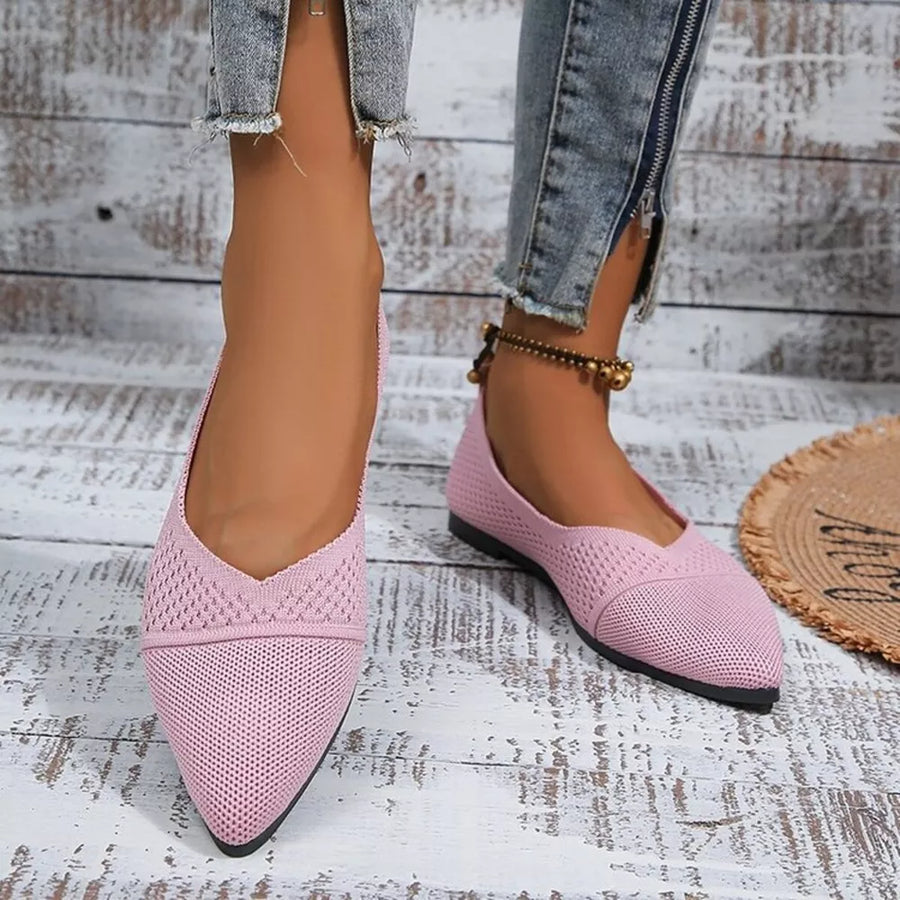 Pink knit pointed toe flats with scalloped trim.