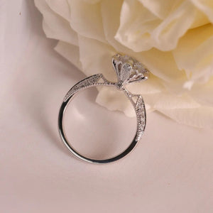 Sterling silver ring with moissanite diamond and pavé band detail