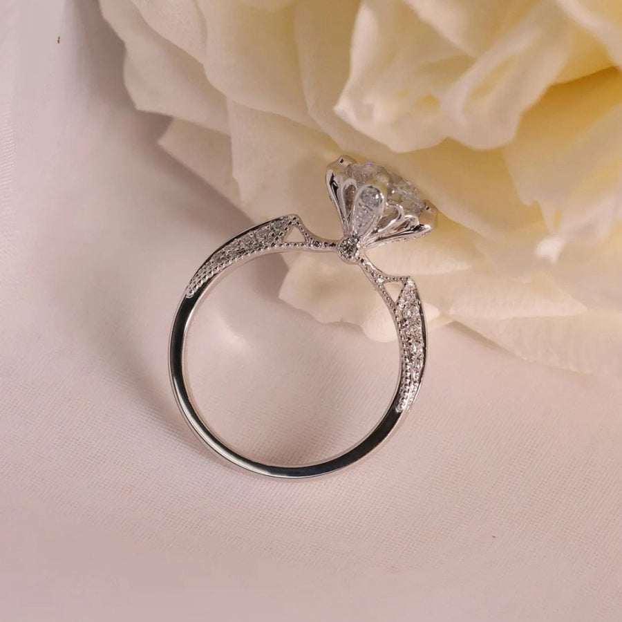 Sterling silver ring with moissanite diamond and pavé band detail