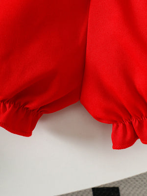 Red baby smocked top and shorts set with ruffled cuffs and hem