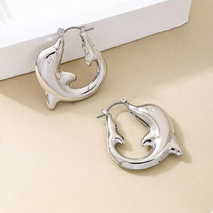 Silver dolphin hoop earrings with a polished finish.