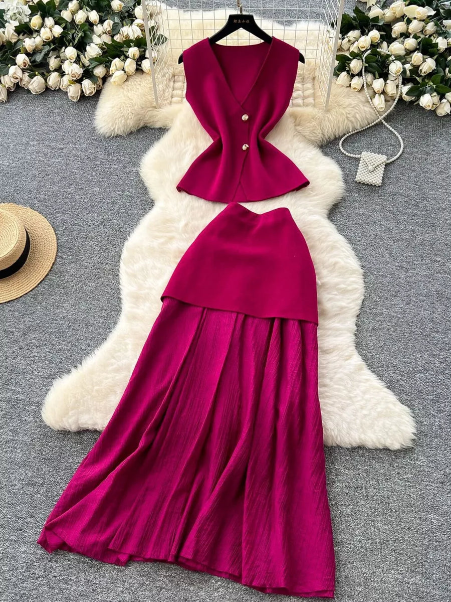 Wine red sheer two-piece set with button details, V-neck sleeveless top and flowing skirt.