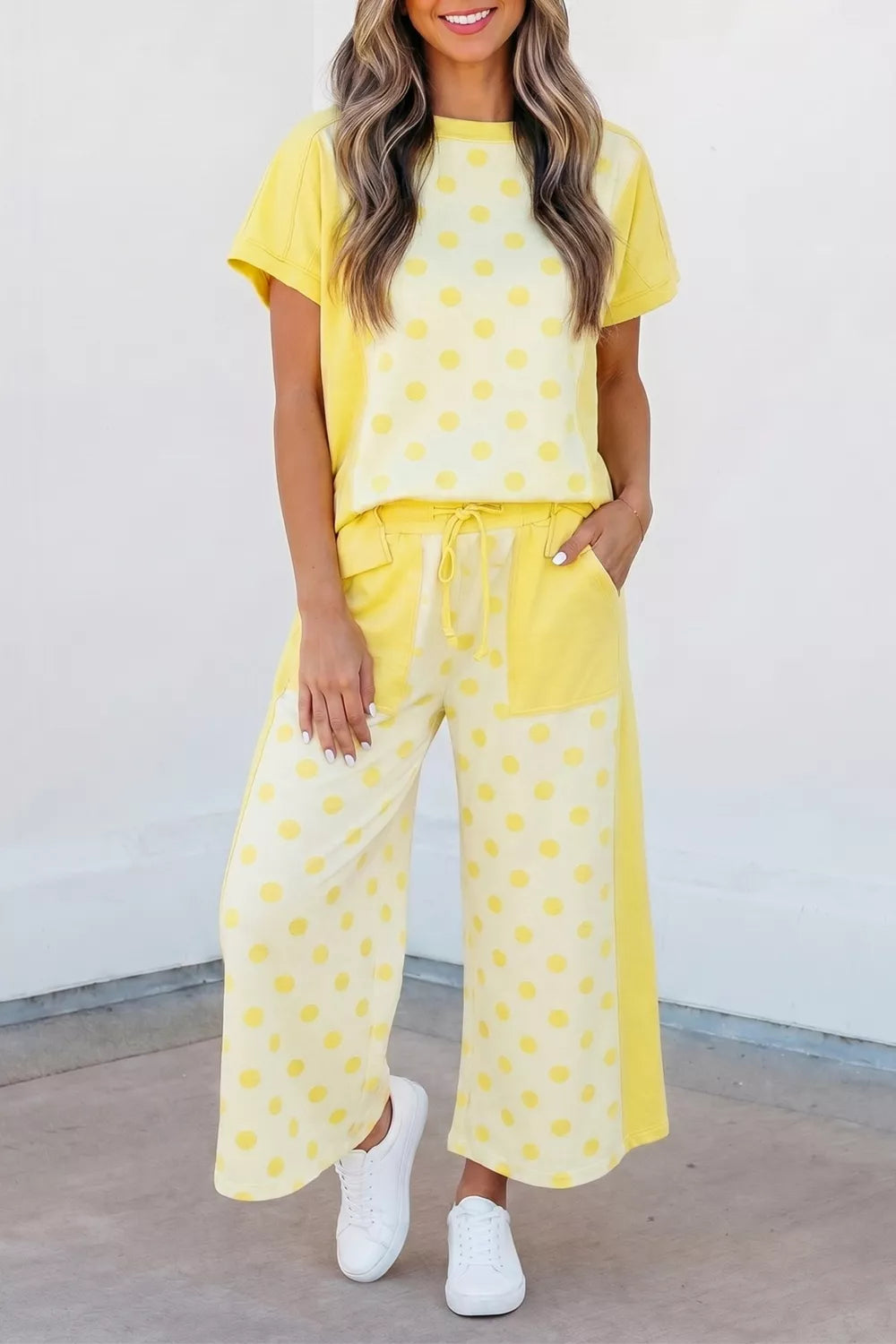 Yellow polka dot cotton blend two-piece set with short sleeve top and wide leg pants.