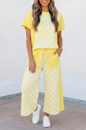 Yellow polka dot cotton blend two-piece set with short sleeve top and wide leg pants.