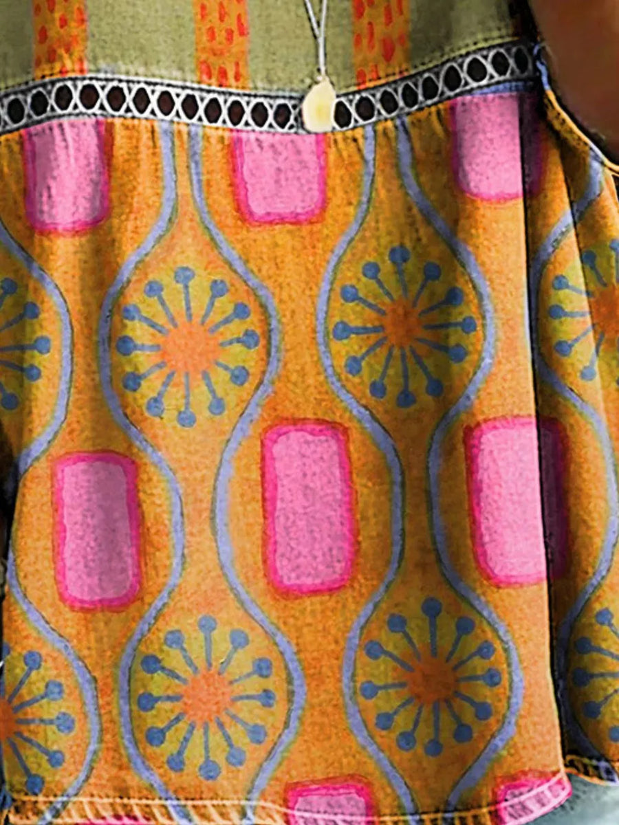 Bohemian floral openwork t-shirt in orange with pink and blue abstract print, featuring a decorative trim.