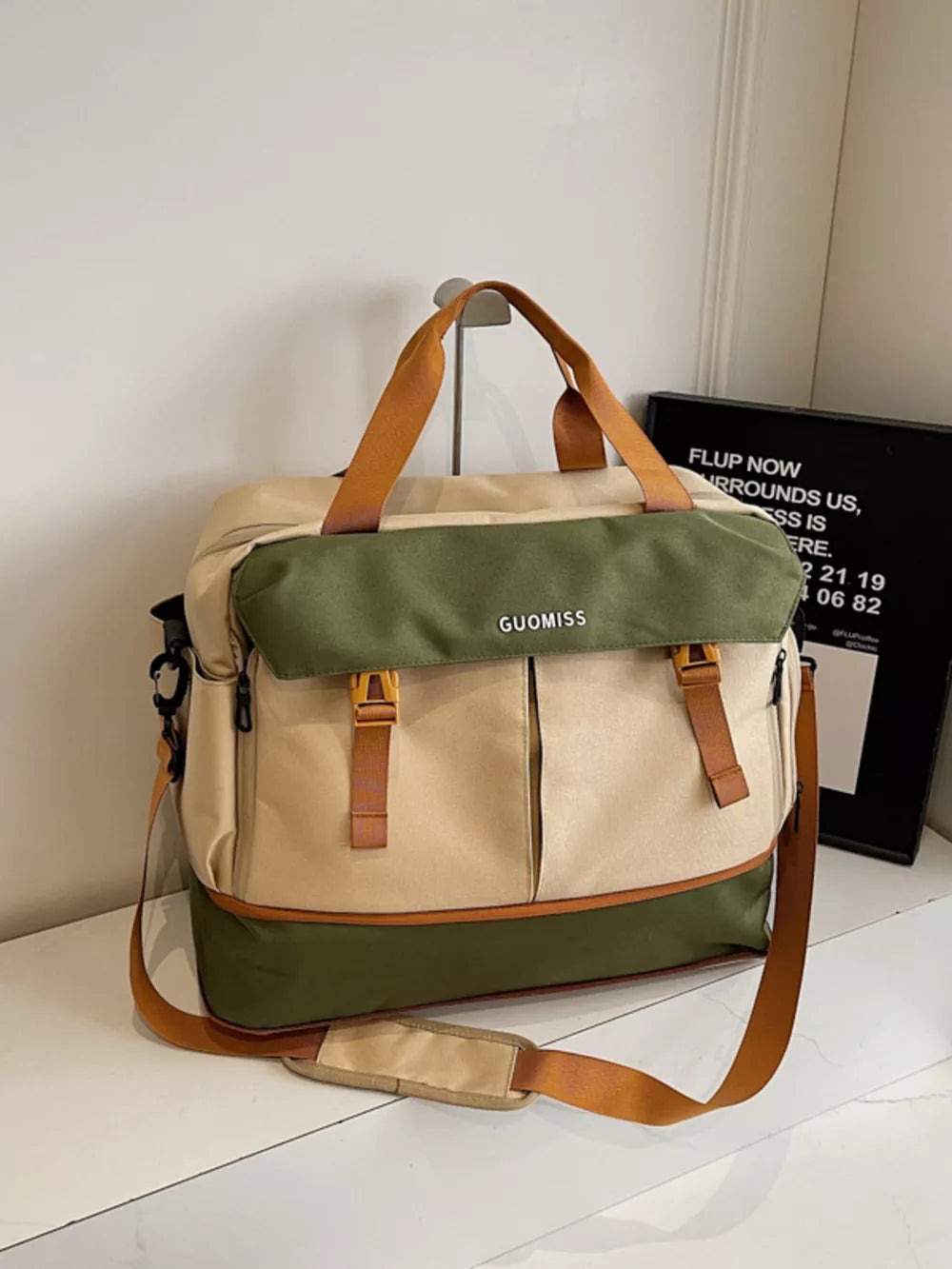 Chic nylon travel bag with olive flap and tan accents, featuring multiple pockets and adjustable straps.